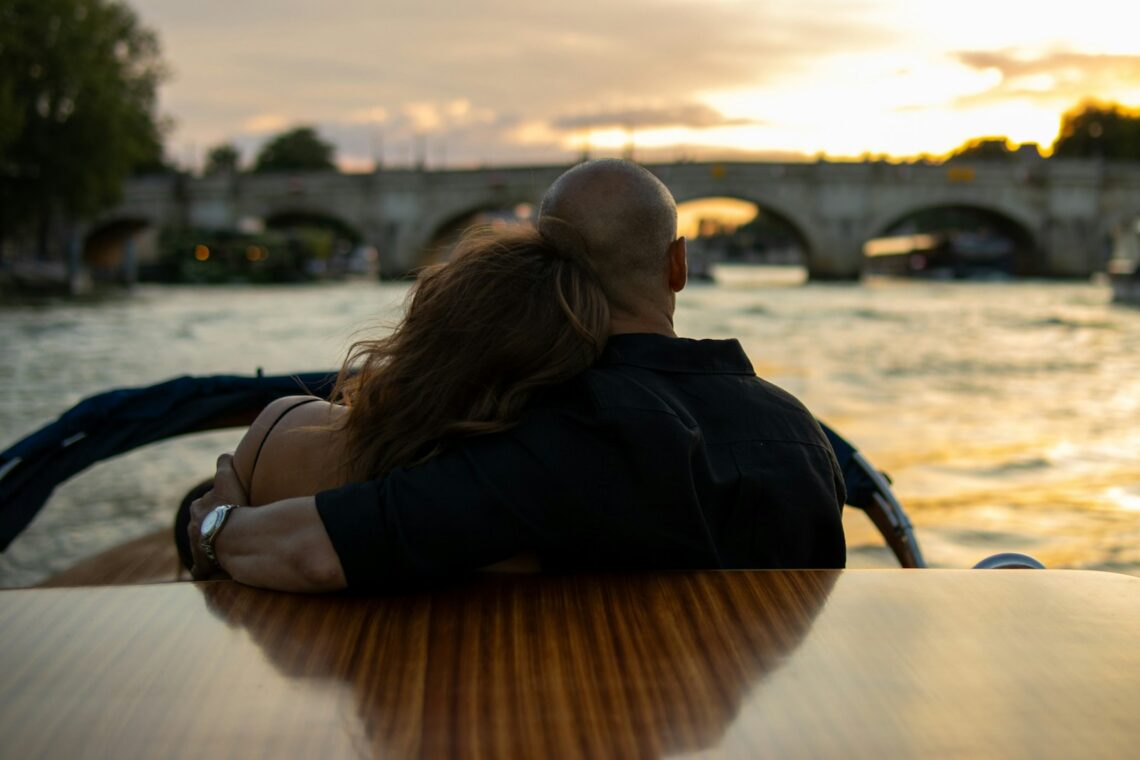 A man and a woman are sitting on a boat