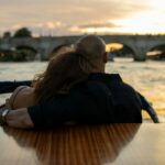 A man and a woman are sitting on a boat