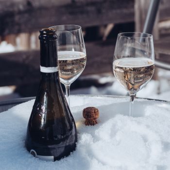 Champagne Bottle and Wineglasses in a Bucket with Snow