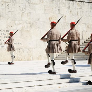 group of people in red and brown uniform playing ice hockey