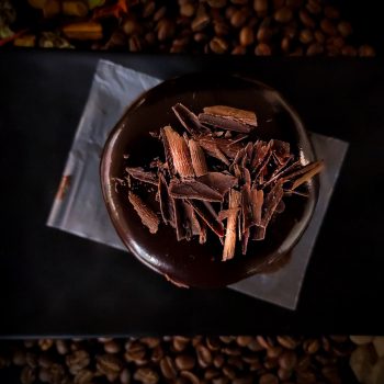 brown and white coffee beans on black paper